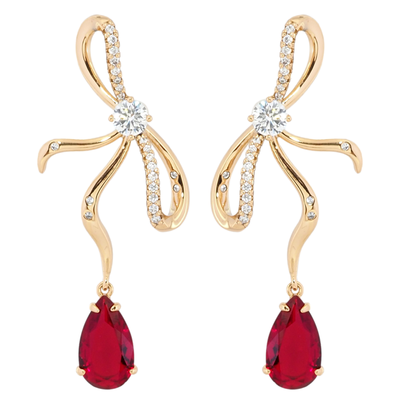 Сережки Xuping Позолота 18K пусети Банти з червоними фіанітами фото №1 Сережки Xuping Позолота 18K пусети Банти з червоними фіанітами фото №1